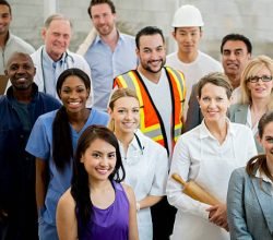 A multi-ethnic group of mixed professionals standing together in their work attire.